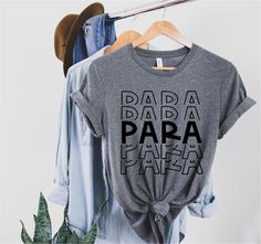 Paraprofessional design on UNISEX t-shirt. See size chart in the photos. **Turnaround time is up to 1-2 weeks** Please note since all tees are handmade, graphic placement may vary slightly. Please see our Policies: https://www.etsy.com/shop/SewBerryCuteBoutique#policies Production: We use only high quality blanks and screen print transfers applied with a professional heat press. ||CARE INSTRUCTIONS|| *Turn inside out for protection. Wash in cold water. *Light dry to low heat in machine to preven Cricut Paraprofessional Gifts, Paraprofessional Svg Free, Sped Paraprofessional Shirts, Paraprofessional Shirts, Paraprofessional Shirts Svg, Mama Hoodie, Cricket Ideas, Teacher Assistant, Screen Print Transfers