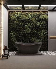 a bathtub in front of a green wall