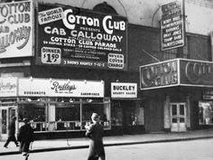 an old black and white photo of people walking in front of cotton club