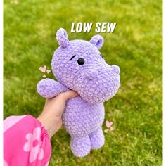 a purple crocheted hippo stuffed animal in someone's hand with the words low sew on it