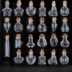 an assortment of glass flasks with cork stoppers in a black box on display