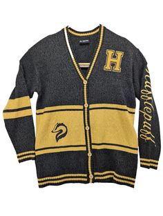 Stay cozy and stylish with this Harry Potter Hufflepuff cardigan from Our Universe. Featuring a striking yellow and black color scheme with the iconic Hufflepuff pattern, this sweater is perfect for any Potterhead. Made from high-quality polyester material, it's not only comfortable but durable as well. The cardigan is sized as Medium and is designed for regular size type for women. With its Hot Topic brand, this cardigan is a must-have for any fashion-forward fan. New Without Tags. Factory Sample  Fast Shipping Black Fall Sweater For College, Winter Cardigan For College, Yellow Winter Sweater For Streetwear, Hufflepuff Cardigan, Hufflepuff Sweater, Harry Potter Hufflepuff, Our Universe, Yellow And Black, Stay Cozy