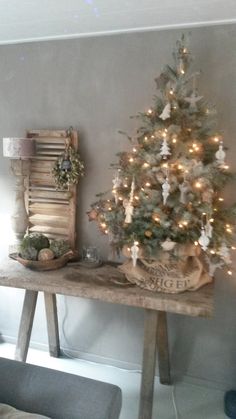 a small christmas tree sitting on top of a wooden table