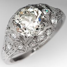 an antique style diamond ring with filigrees