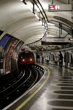 black and white photograph of a subway train pulling into the station