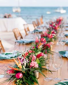 a long table with flowers and wine glasses on it