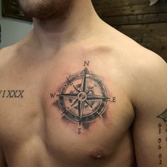 a man with a compass tattoo on his chest