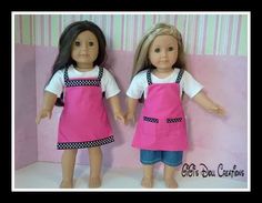 two dolls are standing next to each other