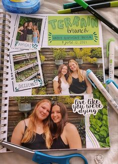 two young women are posing for a photo in their scrapbook, surrounded by crafting supplies