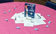 a cat in the hat book on a table with paper streamers all over it