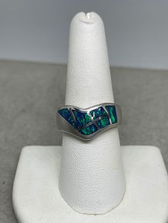 This is a beautiful inlaid Australian opal sterling silver ring that is size 8. This ring features Australian opals that are inlaid into a sterling silver ring. The Opals on this ring originate in Australia and has an amazing fire that ignites in the sunlight. Opals are known for purifying blood, building immunity to help fight off fevers and infections, as well as boosting memory power. Opal is the birthstone associated with the month of October. This ring is handmade and one of a kind. Boost Memory, Australian Opal, Opal Ring, Opal Rings, Rings Statement, Sterling Silver Ring, Favorite Jewelry, Statement Rings, Silver Ring