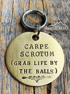 a metal keychain that says carpe scrotum grab life by the balls