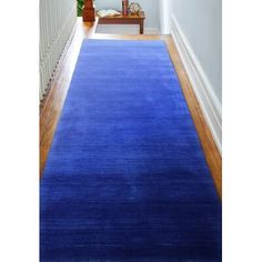 a blue rug on the floor in a hallway