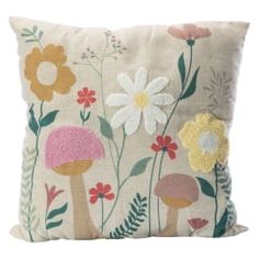 a pillow with flowers and mushrooms on it