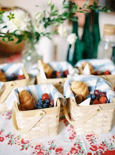 small baskets filled with fruit sitting on top of a table