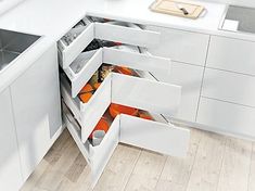 an open drawer in the middle of a kitchen