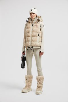 Crafted from plush teddy fleece, this down vest adds a touch of luxury to moments of winter leisure. The warmer is enriched with a trim in nylon laqué, a signature Moncler fabric notable for its glossy texture and water-repellent protection. An adjustable hood completes the design. Personalized Jacket, Cardigan Shirt, Ski Pants, Outerwear Outfit, Fall Jackets, Ski Jacket, Baby Girl Shoes, Ski Wear, Dress With Cardigan