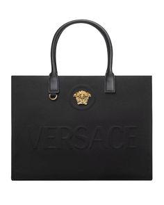 Versace La Medusa Canvas Large Fabric Tote Bag La Medusa hardware Raised logo lettering Double top handles with internal protector strap Internal zipped pocket 15.7” L x 6.3” W x 11.8" H Made in Italy Luxury Shoulder Bag With Logo Hardware For Shopping, Luxury Tote Shoulder Bag With Logo Hardware, Luxury Rectangular Satchel With Logo, Luxury Rectangular Logo Satchel, Designer Rectangular Satchel With Logo, Designer Shopping Shoulder Bag With Logo Hardware, Designer Shoulder Bag With Logo Hardware For Shopping, Modern Bags With Logo Hardware For Daily Use, Designer Bags With Logo For Daily Use