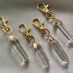 four pairs of gold - plated metal and clear crystal beaded swivel clippers