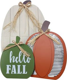 two wooden pumpkins sitting next to each other on top of a white board with the words hello fall written on it