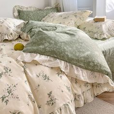 a bed covered in green and white comforters