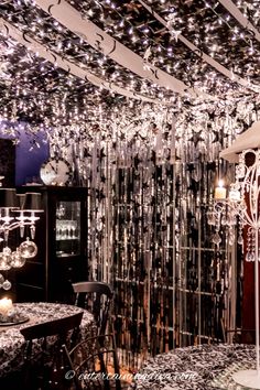 a dining room with chandelier, table and chairs