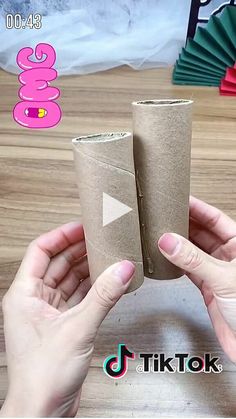 someone is holding two rolls of toilet paper in their hands, with the video below it