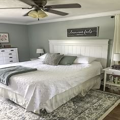 a white bed sitting in a bedroom on top of a rug