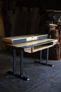 a wooden desk with two drawers on it in a room filled with wood and metal