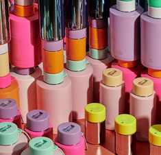 many different colored bottles are lined up together