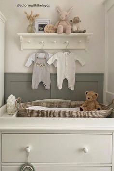 a baby's crib with stuffed animals and toys on the shelf above it