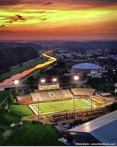 an aerial view of a football stadium at sunset