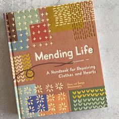 a book on mending life sitting on top of a table