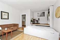 a living room filled with furniture and white walls