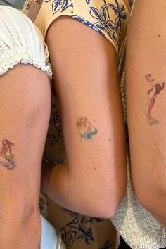 two women with matching tattoos on their legs