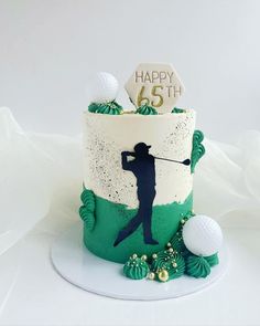 a birthday cake decorated with golf balls and the number 65 on it's side