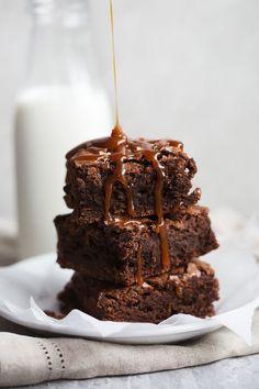 three brownies stacked on top of each other with chocolate drizzled over them