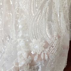 the back of a wedding dress with beading on it