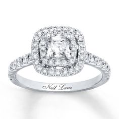 an engagement ring with a cushion cut diamond in the center