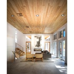 a living room filled with furniture and wooden ceilings