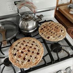 two pies are sitting on top of the stove