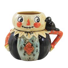 a ceramic coffee mug with a face on it's head and hands holding a black bird