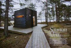 a magazine cover with an image of a cabin in the woods on a wooden platform