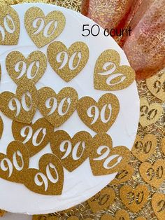 a white plate topped with lots of gold foiled numbers on top of a table