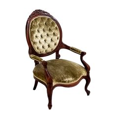 an old fashioned chair that is upholstered with fabric and wood trimmings