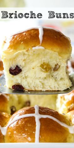 a close up of a bun with cranberries and white icing on it