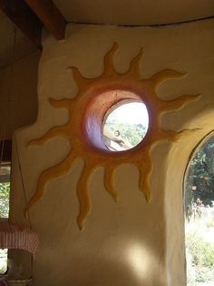 a sun shaped window in the side of a building