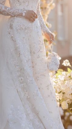 a woman in a wedding dress holding a bouquet