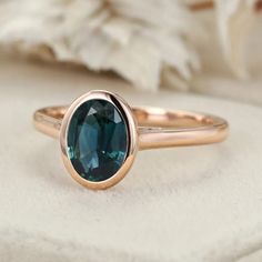 Simplicity in Beauty: Minimalist Oval Cut Bezel Lab Blue Green Sapphire Engagement Ring in 14k Rose Gold. Rose Gold Oval Emerald Ring, Oval Emerald Ring In Rose Gold, 14k Rose Gold Solitaire Oval Jewelry, Rose Gold Oval Sapphire Solitaire Ring, Oval Solitaire 14k Rose Gold Jewelry, Oval Gemstone Ring In 14k Rose Gold, Oval Rose Gold Solitaire Sapphire Ring, Oval Solitaire Sapphire Ring In Rose Gold, Oval Rose Gold Sapphire Solitaire Ring