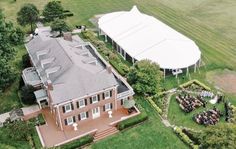 an aerial view of a large house with people sitting on the lawn